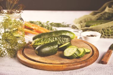 Mutfak masasında salatalık turşusu ve sarımsak.