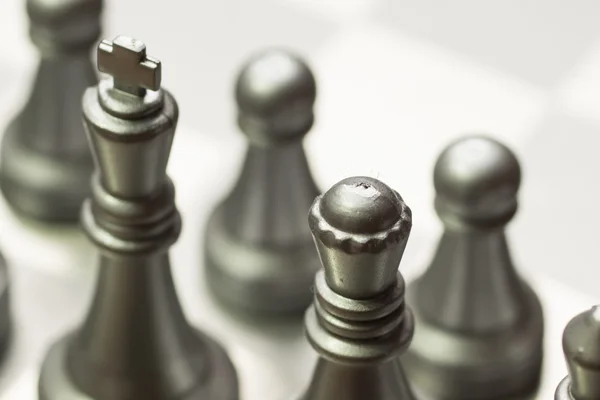 Light and dark wooden chess pieces on chess table. — Stock Photo, Image