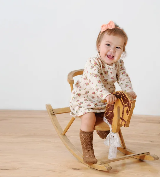 Little girl and horse - rocking chair — Stock Photo, Image