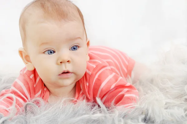 Adorable cute little girl with big blue eyes on the sofa — Stock Photo, Image