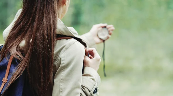 Young woman discovering nature in the forest with compass — Stock Photo, Image