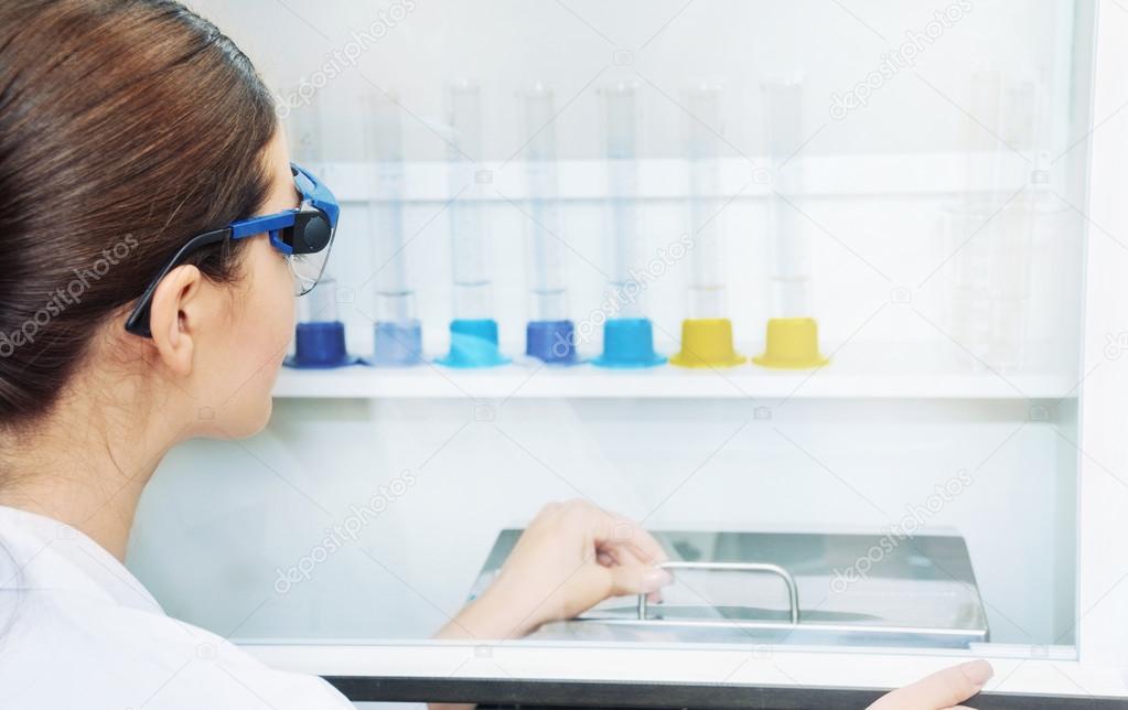 young woman scientist working with liquid at the laboratory