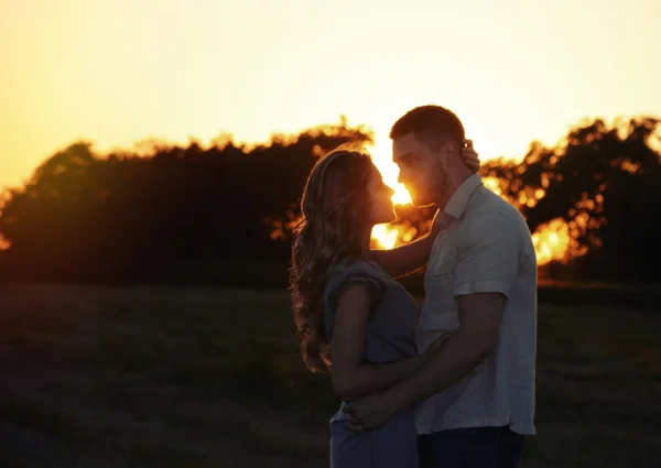 Romantic sensual young couple in love posing in summer field at — Stock Photo, Image