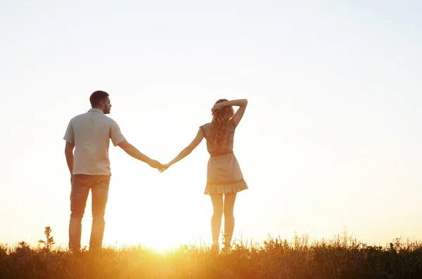 Stunning sensual young couple in love posing in summer field at — Stock Photo, Image