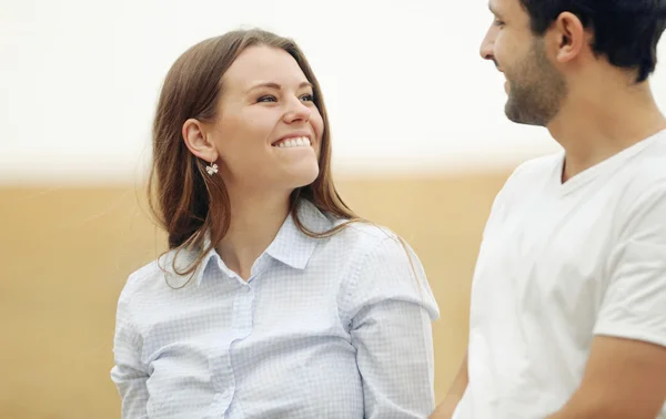 Happy young woman with her man walking together in summer field — Stock Photo, Image