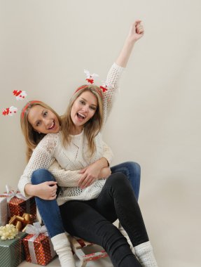 Two happy and funny woman on old sled 
