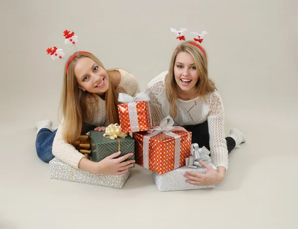 Dos mujeres felices abrazan montón de cajas de regalo —  Fotos de Stock