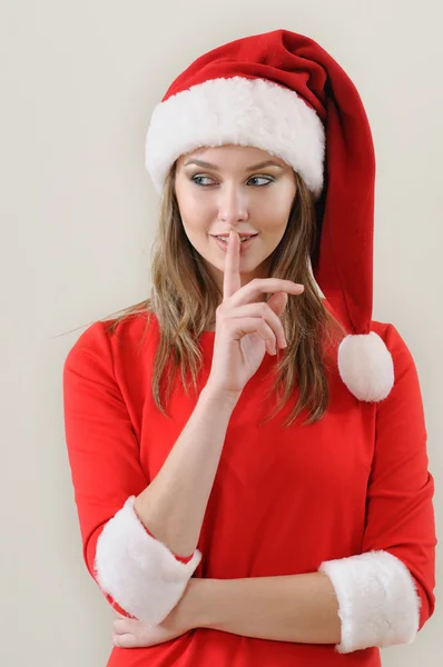 Modestia ragazza indossato in Santa mostrando il silenzio cantare — Foto Stock