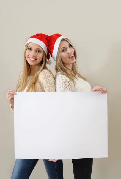 Tho happy girl in santa claus clothes hold empty blank — Stock Photo, Image