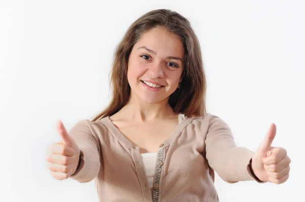 Portrait of a beautiful young woman smiling and holding thumbs u — Stock Photo, Image
