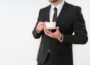 business man body side in black suit with cup of coffee on white