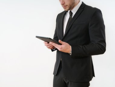business man body side in black suit holding his tablet on white