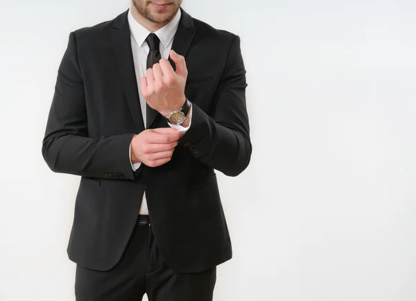 Business man body side button up his black suit on white backgro — Stok fotoğraf