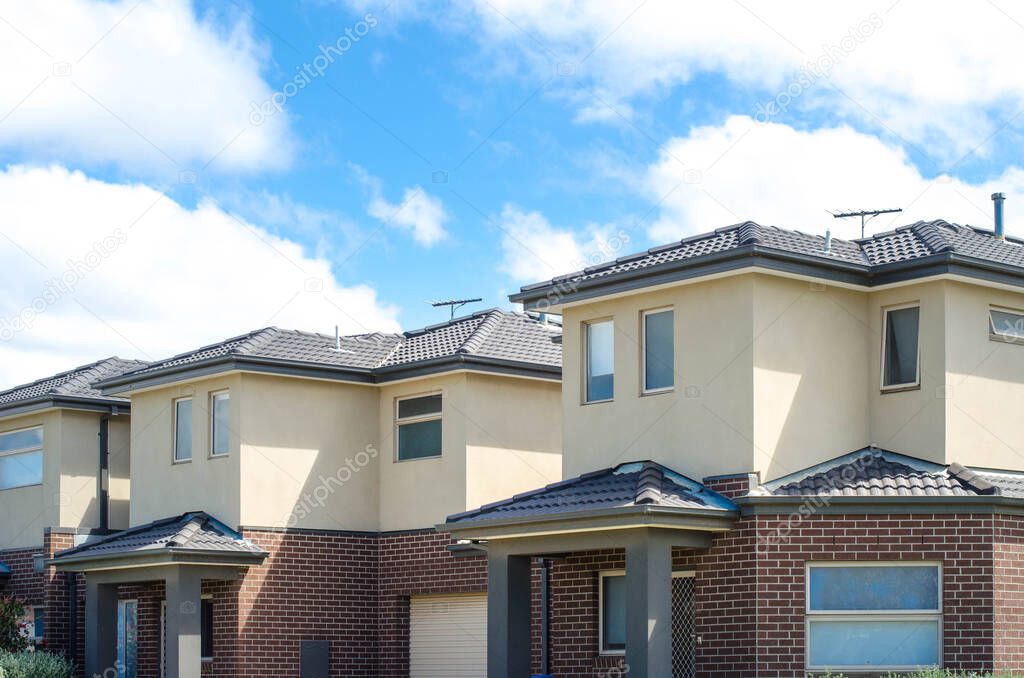 Some Australian modern suburban townhouses in Melbourne's residential neighborhood. Townhouses in Australia are connected to one another in a row and are usually two or three stories tall.