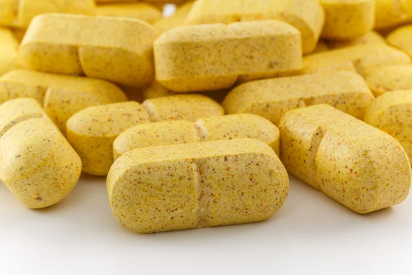 Close up several yellow pills — Stock Photo, Image