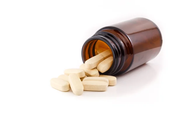 Vitamin pills view brown bottle on side Royalty Free Stock Images