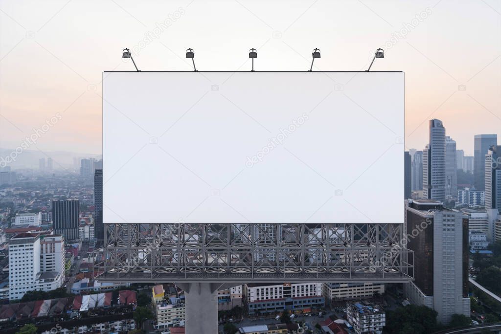 Blank white road billboard with Kuala Lumpur cityscape background at sunset. Street advertising poster, mock up, 3D rendering. Front view.