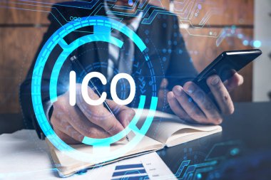 Ofiste telefon ve Meksika engelleme temalı hologram kullanarak not alan bir adam. Çoklu maruz kalma. Resmi giysi.