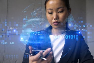 İş kadını telefonu kullanıyor, modern ofiste yeni bir proje üzerinde çalışıyor. Çifte maruziyet. Başarı kavramı. Dünya haritası Dünya hologramı.