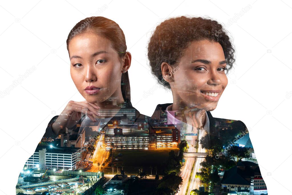 Double exposure of two young, successful, business people, woman, standing in front of Asian city Kuala Lumpur background. Concept of teamwork. Night time.