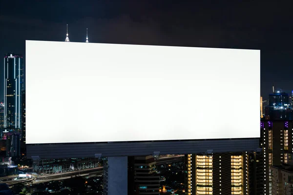 Blank white road billboard with KL cityscape background at night time. Street advertising poster, mock up, 3D rendering. Front view. The concept of marketing communication to promote or sell idea. — Stock Photo, Image