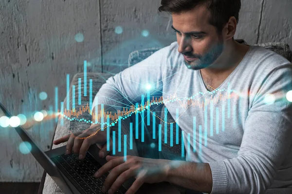 A serious caucasian analyst in casual wears, using laptop to proceed the forecast of stock market behavior. Double exposure. Forex Hologram. Concept of internet trading.