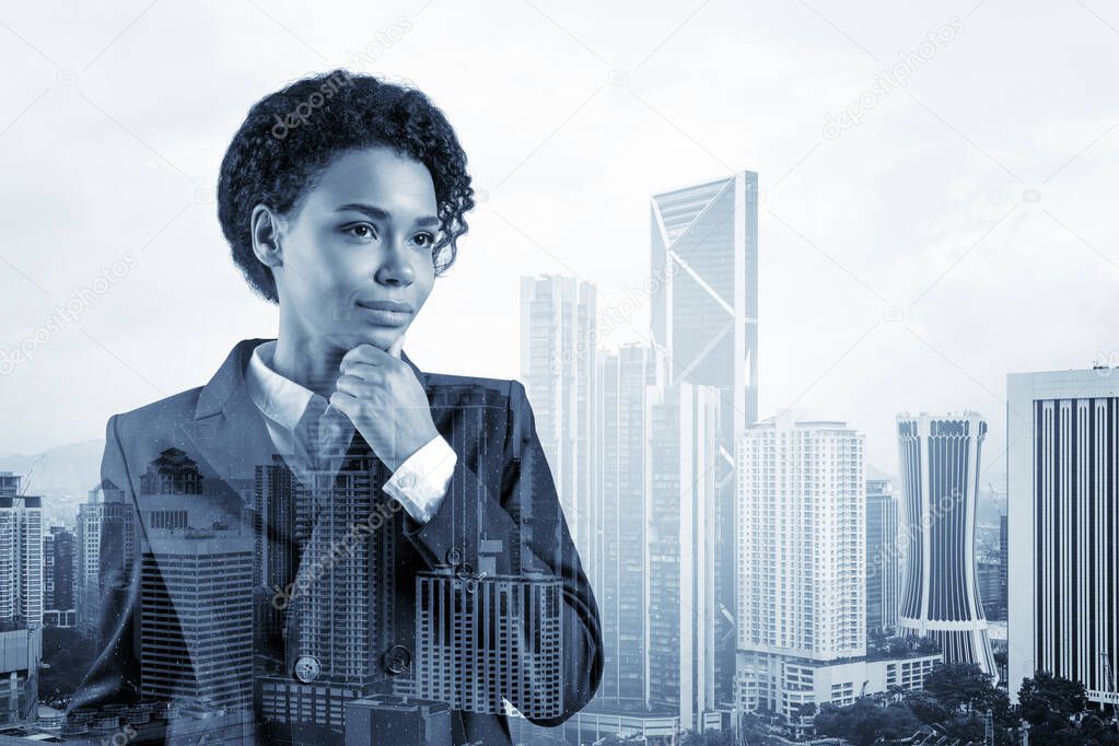 Attractive black African American business woman in suit with hand on chin thinking how to succeed, new career opportunities, MBA. Kuala Lumpur on background. Double exposure.