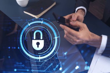 Bir programcı, bir siber güvenliği hacker saldırılarından korumak ve müşterilerinin gizli verilerini kaydetmek için akıllı telefonuyla internete giriyor. Hologram simgelerini daktilo eden ellerin üzerine kilitle. Resmi giysi.