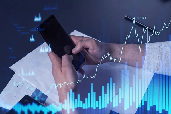 Trader holding in the hands a smart phone and researching stock market to proceed right investment solutions. Internet trading and wealth management concept. Hologram Forex chart over close up shot. — Stock Photo, Image