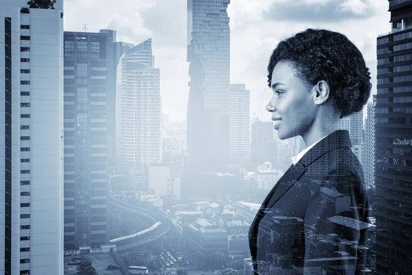 Successful smiling black African American business woman in suit. Bangkok cityscape. The concept of woman in business. Legal consultant. Double exposure.