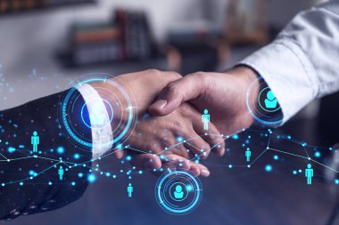 Uluslararası şirketler için yeni yetenekli uzmanlar işe alma kavramı. İş sözleşmesi imzalamak için el sıkışmak bir anlaşma konsepti. Sosyal medya hologram simgeleri.