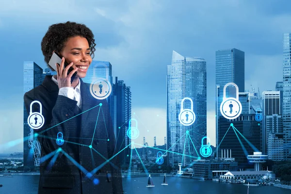 Attractive black businesswoman developer having conference call to protect clients confidential information by inventing solutions. IT lock icons over Singapore city background.