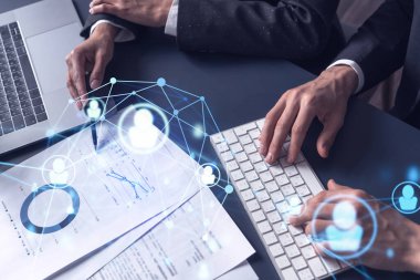 İki İK uzmanı, uluslararası danışmanlık şirketindeki stajyerlik programını geliştirmek için mezunlar pazarını inceliyor. Yeni yetenekli memurlar işe almak. Sosyal medya hologram simgeleri.