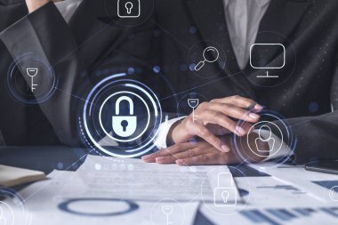 Uluslararası şirketin siber güvenliğini korumak için projede çalışan iki iş kadını. Belgelerle birlikte masadaki Hologram simgelerini kilitle.