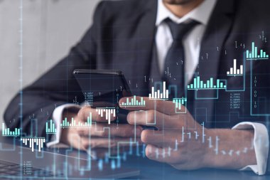 Elinde akıllı bir telefon tutan tüccar doğru yatırım çözümlerine ulaşmak için borsayı araştırıyor. İnternet ticareti ve zenginlik yönetimi kavramı. Hologram Forex grafiği yakın çekim üzerine.
