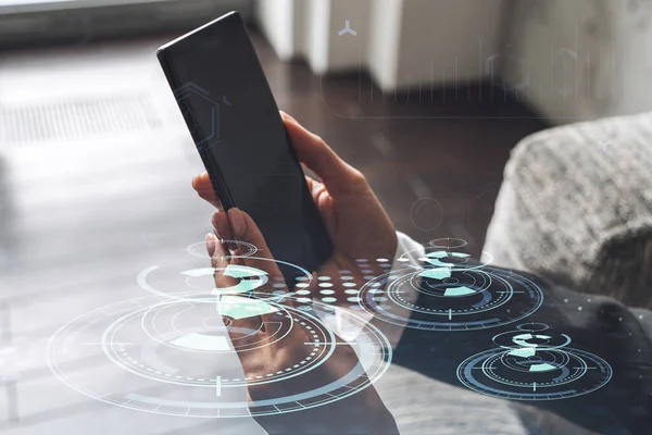 Businesswoman in formal wear holding in the hands a smart phone and testing an innovative application to provide a completely new service. Close up shot. Hologram tech graphs. Concept of Dev team. — Stock Photo, Image