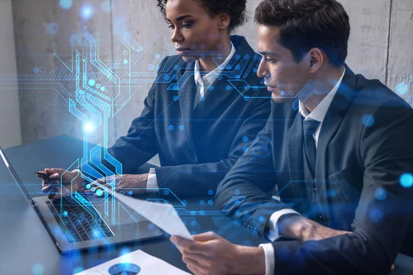 Two good looking businesspeople working together in office on IT project. Technology hologram drawings. Double exposure. Formal wear. — Stock Photo, Image