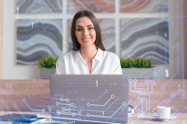 Attractive businesswoman in white shirt at workplace working with laptop to optimize development by implying new technologies in business process. Hi tech hologram over office background