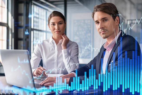 Businessman and businesswoman in formal wear working together to optimize trading strategy at corporate finance fund. Forex chart hologram over office background with panoramic windows — Stock Photo, Image