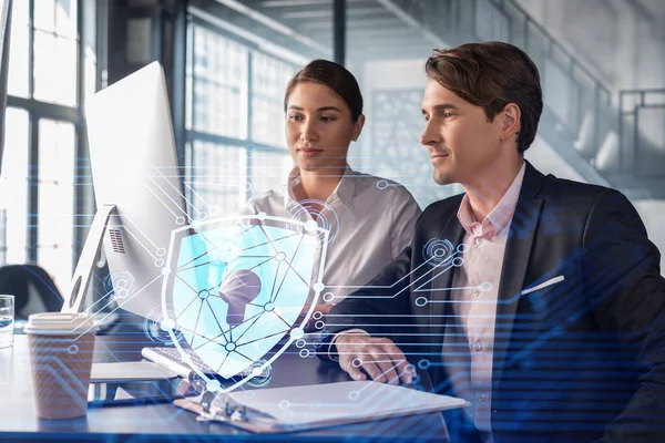 Businessman and businesswoman working together to protect clients confidential information and cyber security. IT hologram padlock icons over office background with panoramic windows. — Stock Photo, Image