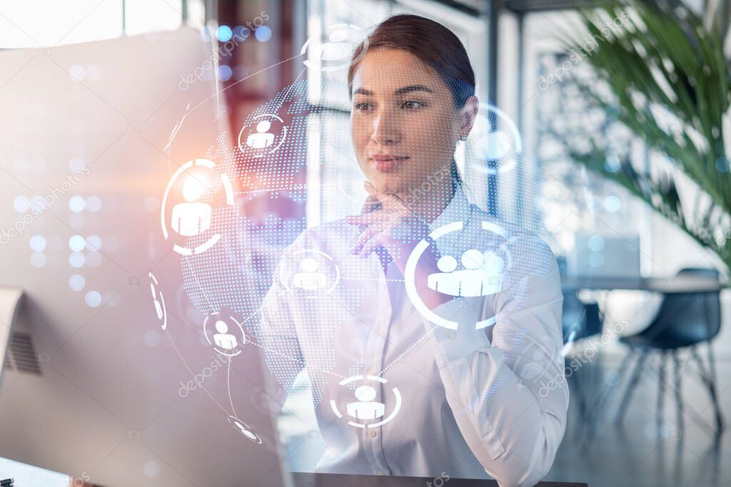 Attractive businesswoman in white shirt at workplace working with laptop to hire new employees for international business consulting. HR, social media hologram icons over office background