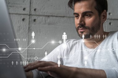 Yeni bir ağ geliştirmek için dizüstü bilgisayar kullanan ciddi bir Kafkasyalı yönetici. Çifte maruziyet. Sosyal medya hologramı.