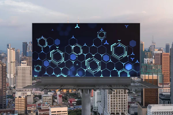 Glowing hologram of technological process on billboard, aerial panoramic cityscape of Kuala Lumpur at sunset. KL is the largest innovative hub of tech services in Malaysia, Asia.