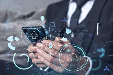 Programcı elinde akıllı bir telefon tutuyor ve tamamen yeni bir hizmet sunmak için yenilikçi bir uygulamayı test ediyor. Yakın çekim. Hologram teknik grafikleri. Dev takım kavramı. Resmi giysi.