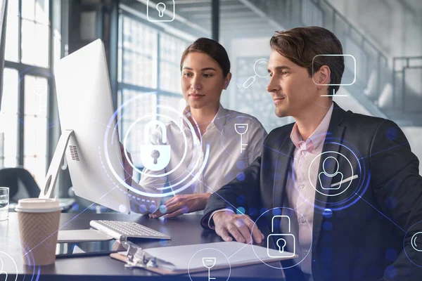 Businessman and businesswoman working together to protect clients confidential information and cyber security. IT hologram padlock icons over office background with panoramic windows. — Stock Photo, Image
