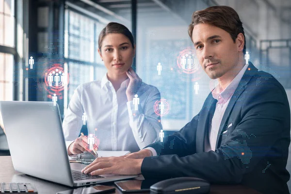Businessman and businesswoman in formal wear working together looking for new employees to hire for international business consulting. HR, social media icons over modern panoramic office background — Stock Photo, Image