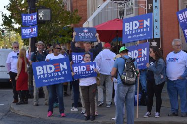 Westerville, Ohio October 15, 2019: Political candidate supporters and protesters near by Otterbein College the eve of CNN's 2020 DNC debate. Featured: Supporters for President-Elect Joe Biden. clipart