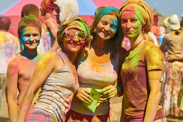 Russia, Arkaim 2015.06.21 four beautiful girls from head to toe soiled in paint at the Holi festival