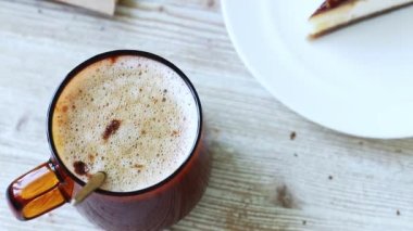 Ahşap bir masada duran bir fincan aromatik kahve..