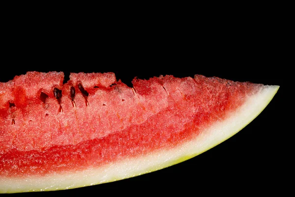 slice of juicy ripe red watermelon on black background